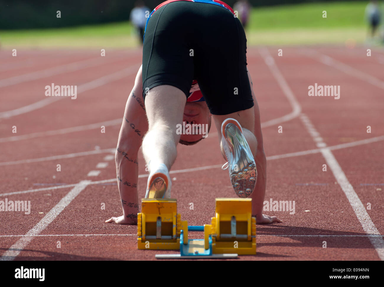 Athletics, runner at start of men`s 100m race at club level, UK Stock